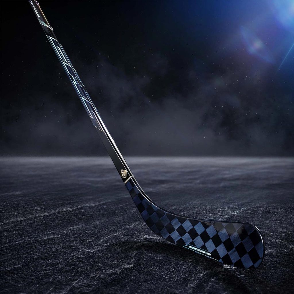 Photo of blade and shaft of Hyperion 24K sapphire carbon fiber hockey stick on dramatic dark ice.
