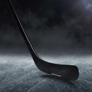 UD carbon fiber hockey stick sitting on a frozen lake.